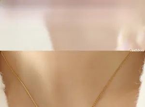 Close-up of a delicate gold heart shell necklace worn by a model for a stylish look