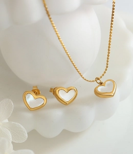 Close-up of heart-shaped white shell jewelry set including necklace and earrings