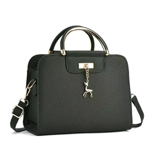 Detail of dark green pebbled leather handbag with golden deer charm and metal handle