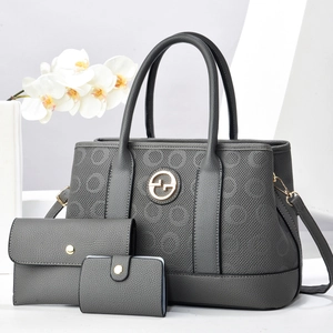 Three-piece charcoal gray tote set with pebble leather texture and metal logo
