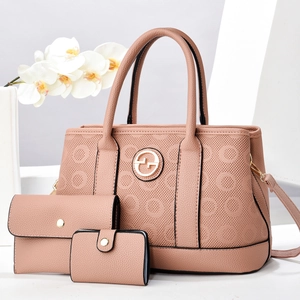 Three-piece pink lychee faux leather handbag set with tote, wallet, and mini pouch