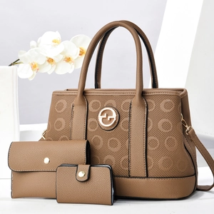 Close-up of textured earth-tone tote set showing gold logo and premium pebbled faux leather