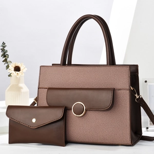 Detail of dark brown woven tote bag set with metal ring and matching envelope clutch