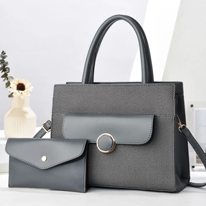 Detail of dark gray woven tote bag with matching envelope pouch and golden buckle