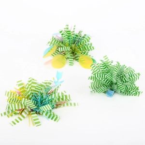 Detail of colorful Easter egg hair clips with fuzzy texture and green striped ribbons