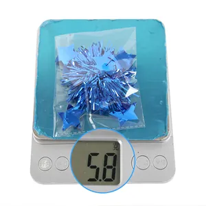 Close-up showing 5.8g of blue star foil party decorations being weighed on a scale