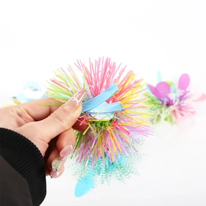 Detail of colorful Easter tassel hair clip with pink yellow blue tinsel on metal duckbill clamp