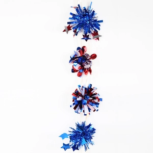 Detail of Independence Day hair clip with red white blue stars and tinsel fringe