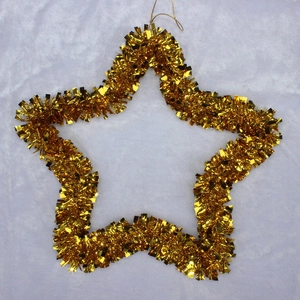 Detailed view of a golden tinsel star ornament with hanging loop for festive decoration