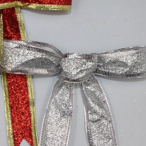 Close-up of 15cm silver and red glitter Christmas bows for tree decoration and gift wrapping