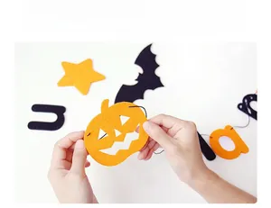 Detailed view of Halloween felt banner parts featuring laser-cut pumpkin and bat designs