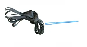 Detail of black woven Halloween banner string and light blue plastic threading needle tool