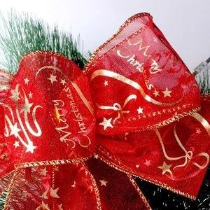 Red sheer Christmas ribbon with gold Merry Christmas print and star patterns