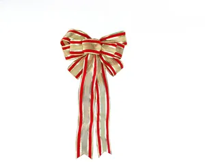 Detail of a red and gold striped Christmas bow with metallic edges for holiday decoration