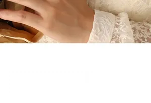 Detailed close-up of delicate floral lace sleeves and cuff detail for female accessories
