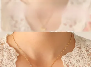 Detail shot of a 18K gold-plated lip-link chain necklace with a smooth metallic texture