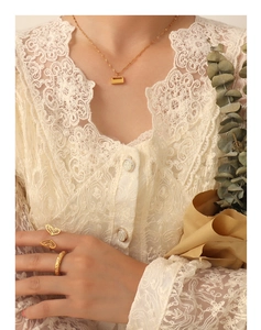 Close-up of gold 18K plated necklace with padlock pendant and butterfly hollow ring