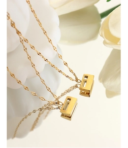 Macro shot of 18K gold plated titanium steel necklace with rectangle pendant