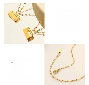 Detail of 18K gold plated lock pendant and clasp mechanism on a titanium steel necklace