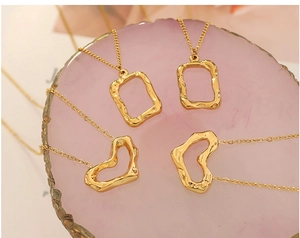 Detailed view of gold hammered texture heart and rectangle pendant necklace