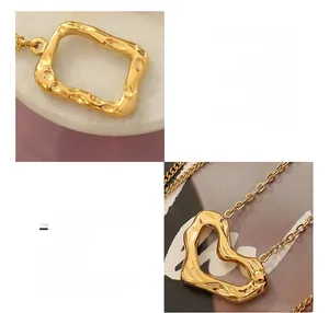 Detailed macro view of heart and rectangle pendants on 18K gold plated titanium steel chain