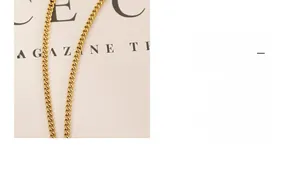 Macro shot of gold-plated cuban chain necklace link details and glossy metal finish