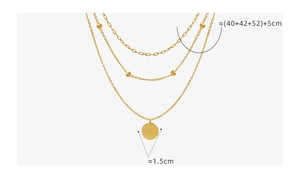 Macro view of triple-layered 18K gold-plated necklace featuring a Good Luck coin pendant