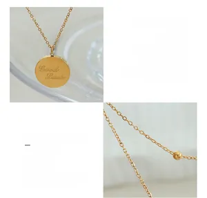 Detailed macro view of triple-layered titanium necklace with Good Luck gold coin pendant