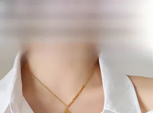Detailed view of the gold-plated D-letter square pendant on a delicate chain necklace
