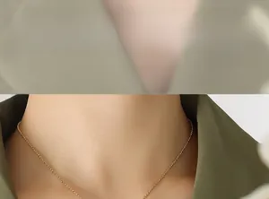 Close-up of gold interlocking pendant necklace on model showing delicate chain detail