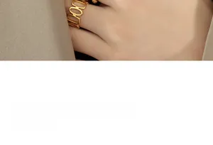 Macro view of gold plated hollow oval chain link ring for women with minimalist finish