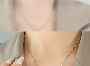 Close-up of minimalist gold snake chain necklace showing the smooth fit on model's neck