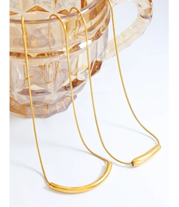 Detailed view of an 18K gold-plated snake chain with a curved tube smile pendant