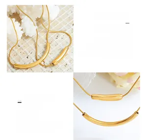 Macro shot of 18K gold plated titanium steel smile pendant with fine snake chain detail