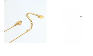 Close-up of lobster clasp and K18 engraved tag on gold plated stainless steel necklace