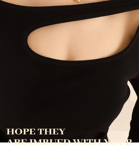 Close-up of black ribbed knit top featuring a stylish front cutout and textured fabric