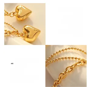 Macro detail of 18K gold plated heart pendants with dual chain stitching textures