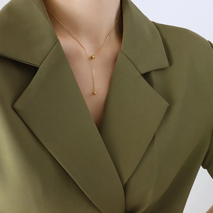 Minimalist double layer gold bead Y-shaped necklace in titanium steel on a blazer