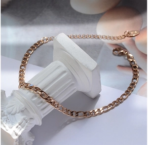 Detail of rose gold Figaro chain anklet on a Roman pillar with lobster clasp and extender