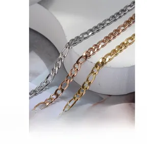 Detailed close-up of Figaro style metal anklet chains in gold, silver, and rose gold
