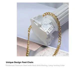Macro detail of thick gold plated titanium steel cuban chain anklet on a white pedestal