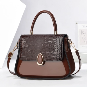 Détail du sac à main marron foncé embossé crocodile avec finition vernie et boucles dorées
