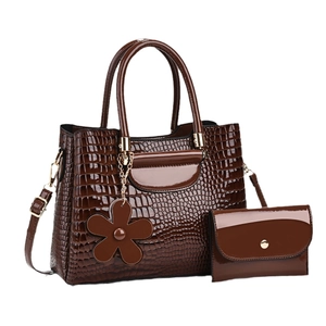 Brown crocodile embossed faux leather handbag set with glossy finish and flower charm