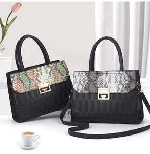 Detail of elegant black handbags featuring snake skin texture flaps and gold metal buckles