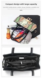 Detail of snake pattern flap and internal compartments of black tote handbag