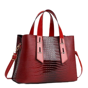 Deep red crocodile pattern leather handbag with golden hardware and adjustable strap