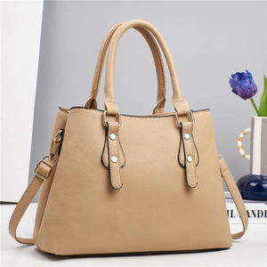 Elegant beige lychee leather tote bag with gold rivets and detachable shoulder strap