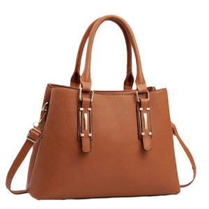 Elegant tan lychee texture crossbody handbag with golden buckles and top handles