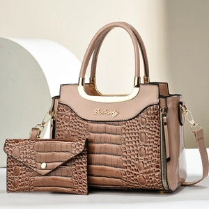 Elegant apricot crocodile pattern handbag set with golden circular handles and matching wallet
