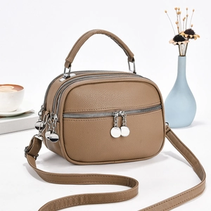 Brown litchi grain leather crossbody bag featuring four layers of zipper compartments